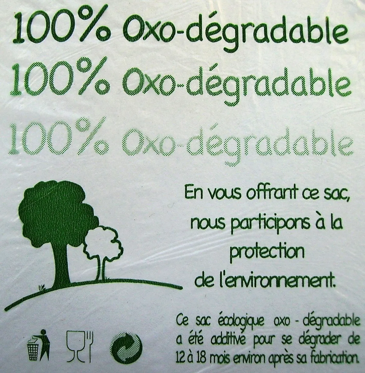 Plastic bag printed "100% oxo-degradable" and "By giving you this bag, we help protect the environment", with a stylised tree