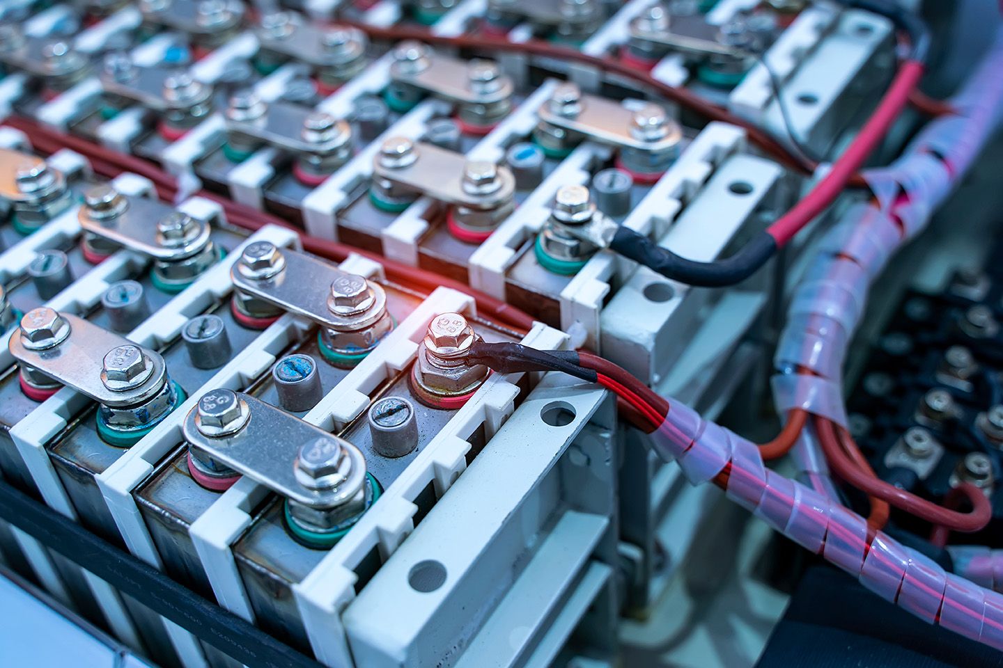 Close-up of cylindrical lithium-ion cells bolted onto a battery module