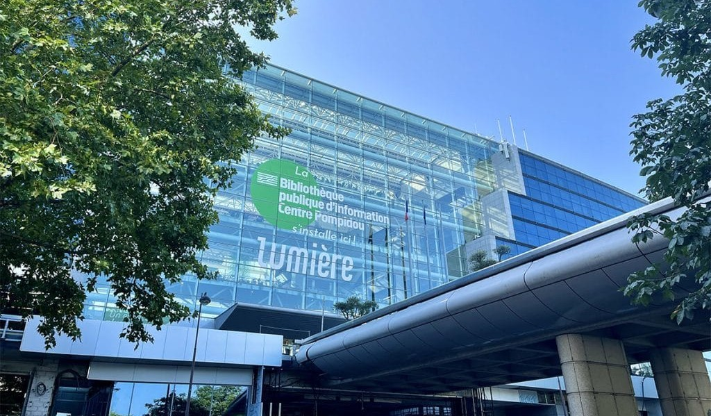 Glass façade of a modern commercial building, the type of site whose carbon footprint is measured