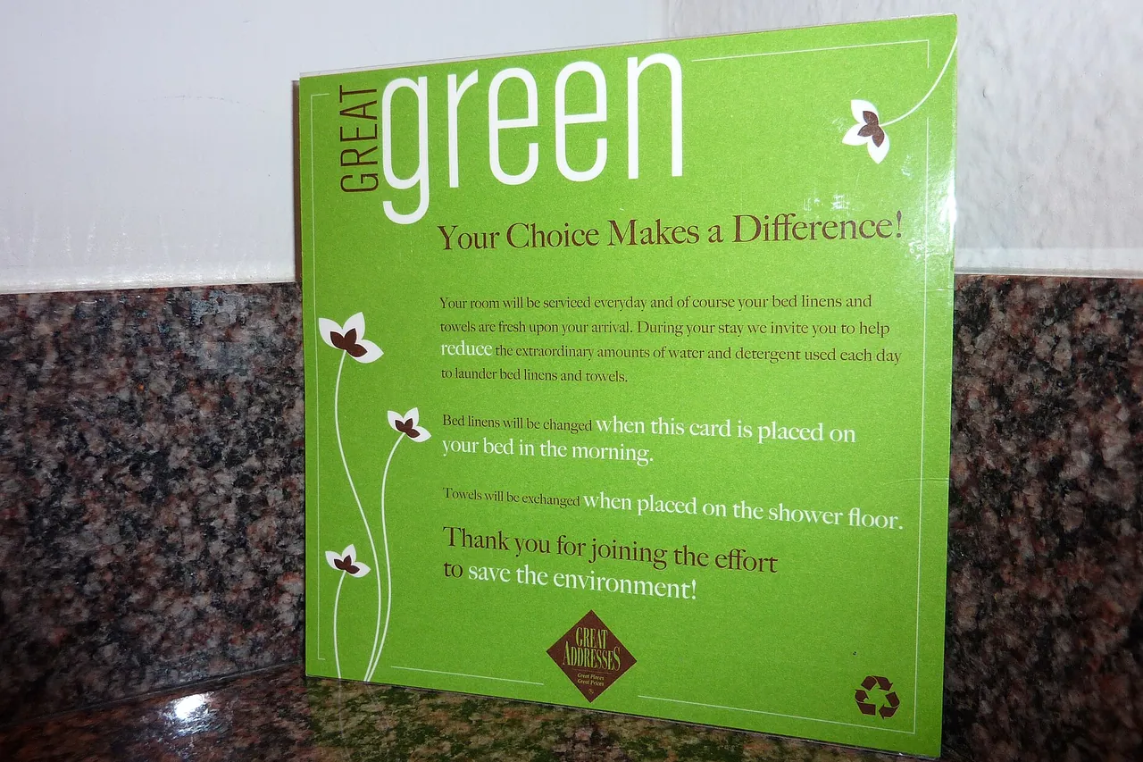 Green card headed "Great green" placed on a granite countertop, inviting a hotel guest to keep sheets and towels