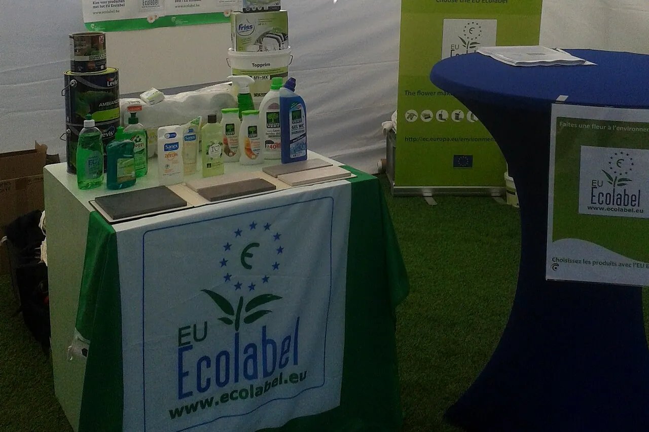Promotion stand for the EU Ecolabel: a table covered with a cloth bearing the label's logo, with cleaning products and paint pots