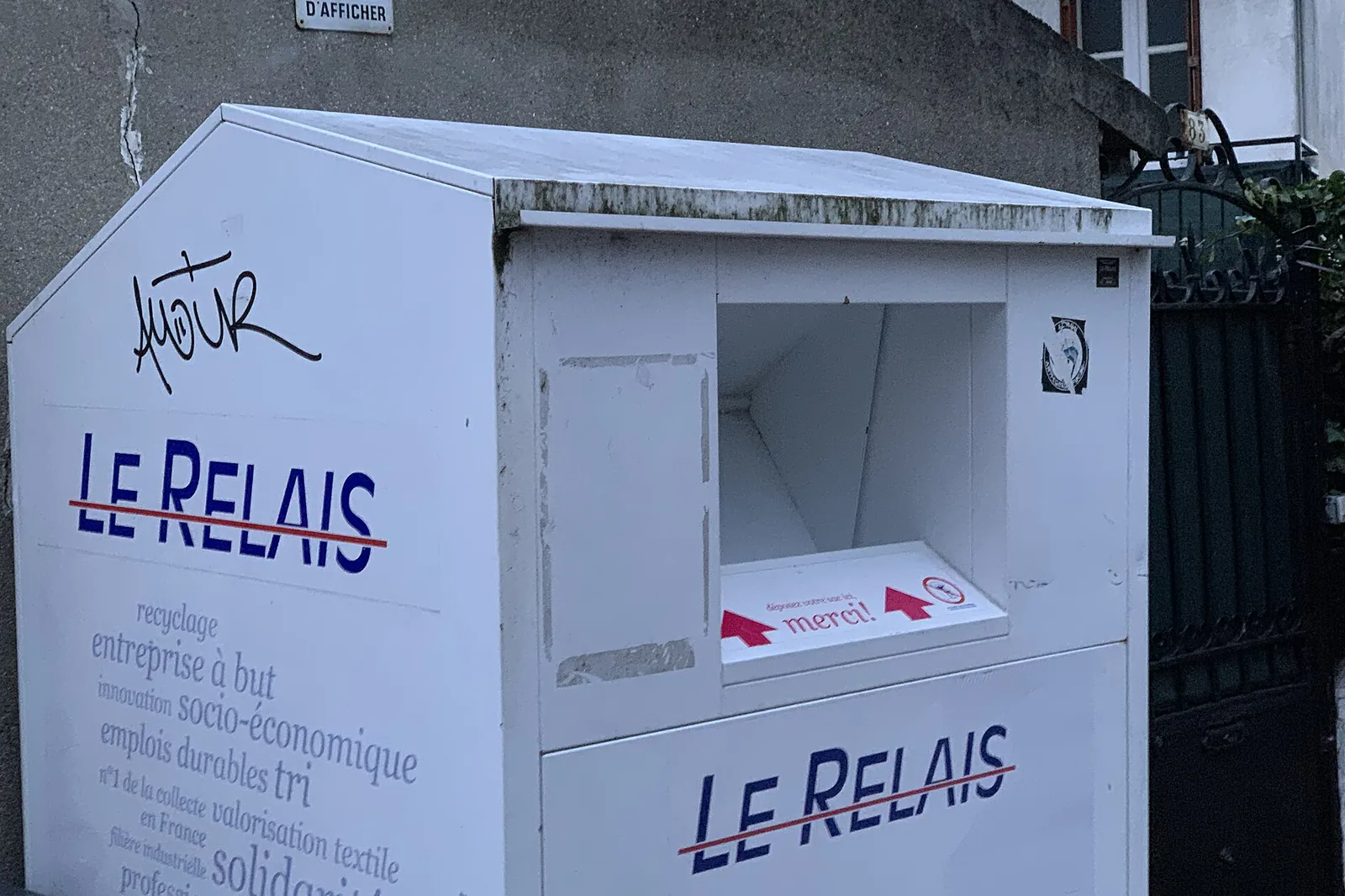 White Le Relais clothing collection container on a pavement