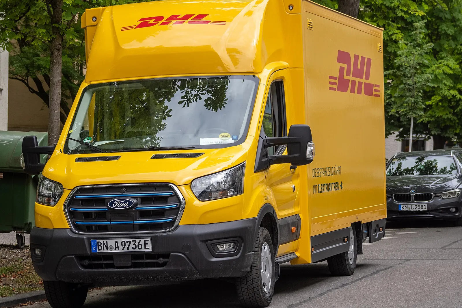 Electric Ford E-Transit van with a parcel carrier’s yellow body, parked in a car park in 2026