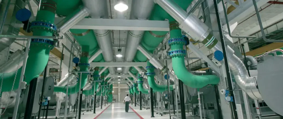District cooling production plant, with green chilled-water circulation pipes