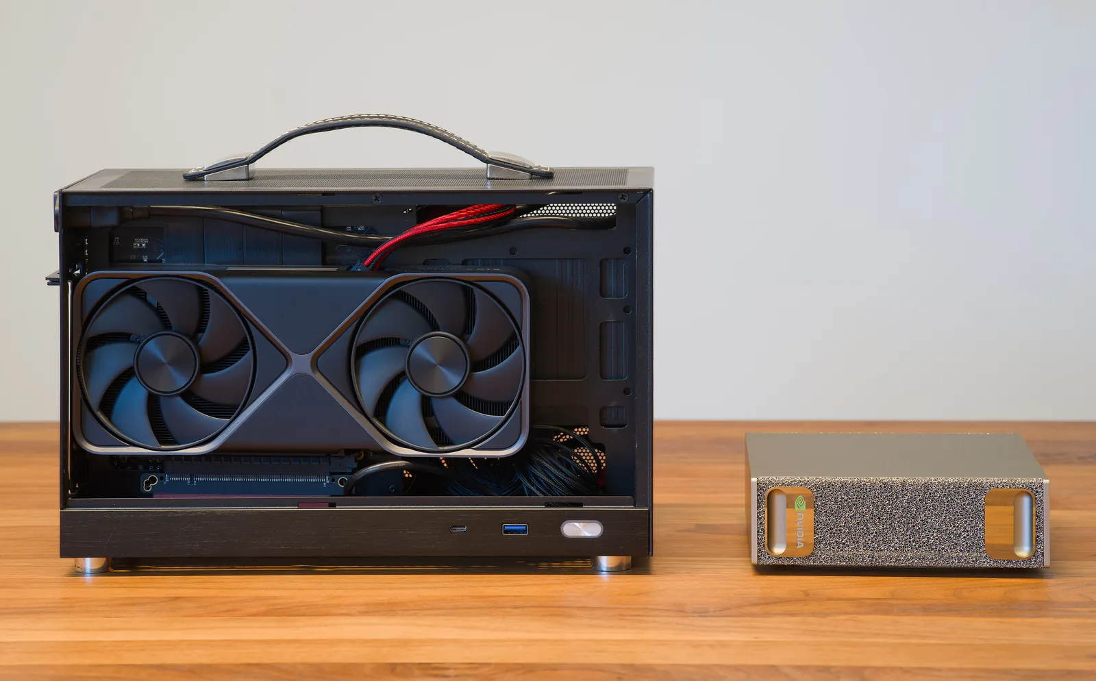 A small desktop computer with an open case, whose graphics card with 2 fans takes up almost the whole interior