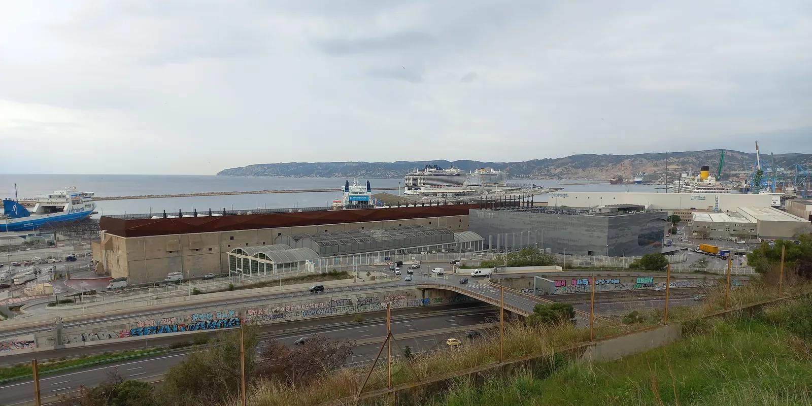 High-angle view of the Digital Realty data centre buildings in the port of Marseille, with ferries at the quayside