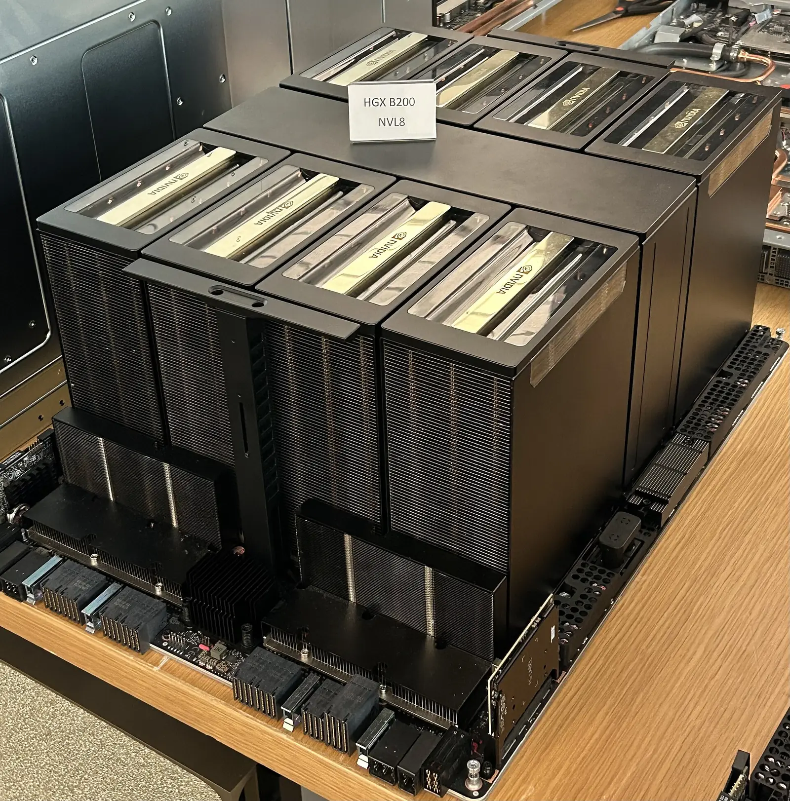 An Nvidia server tray with 8 graphics cards, pulled out of its chassis and placed on a table