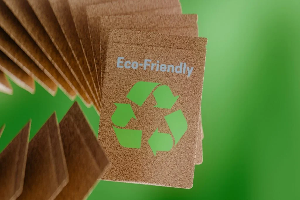 Close-up of ribbed brown kraft cardboard with an Eco-Friendly label and recycling symbol: single-material fibre as an alternative to plastic subject to PCR content requirements