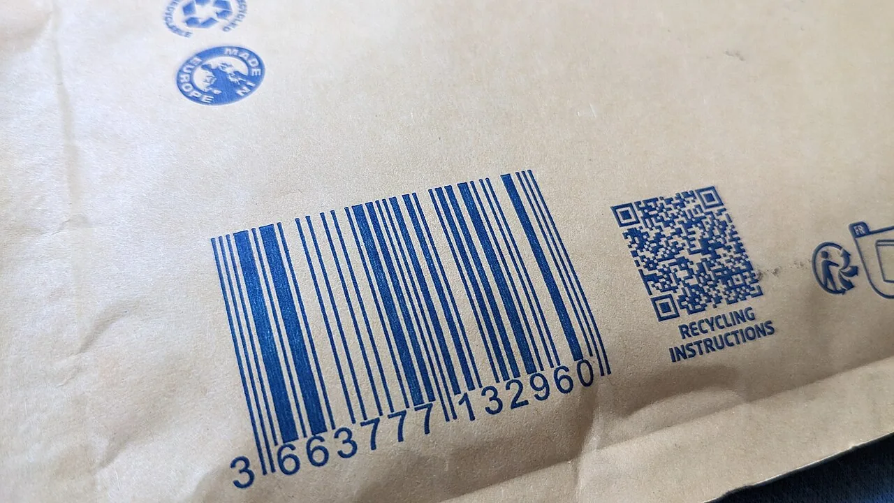 Barcode and "Recycling instructions" QR code printed in blue on a kraft envelope