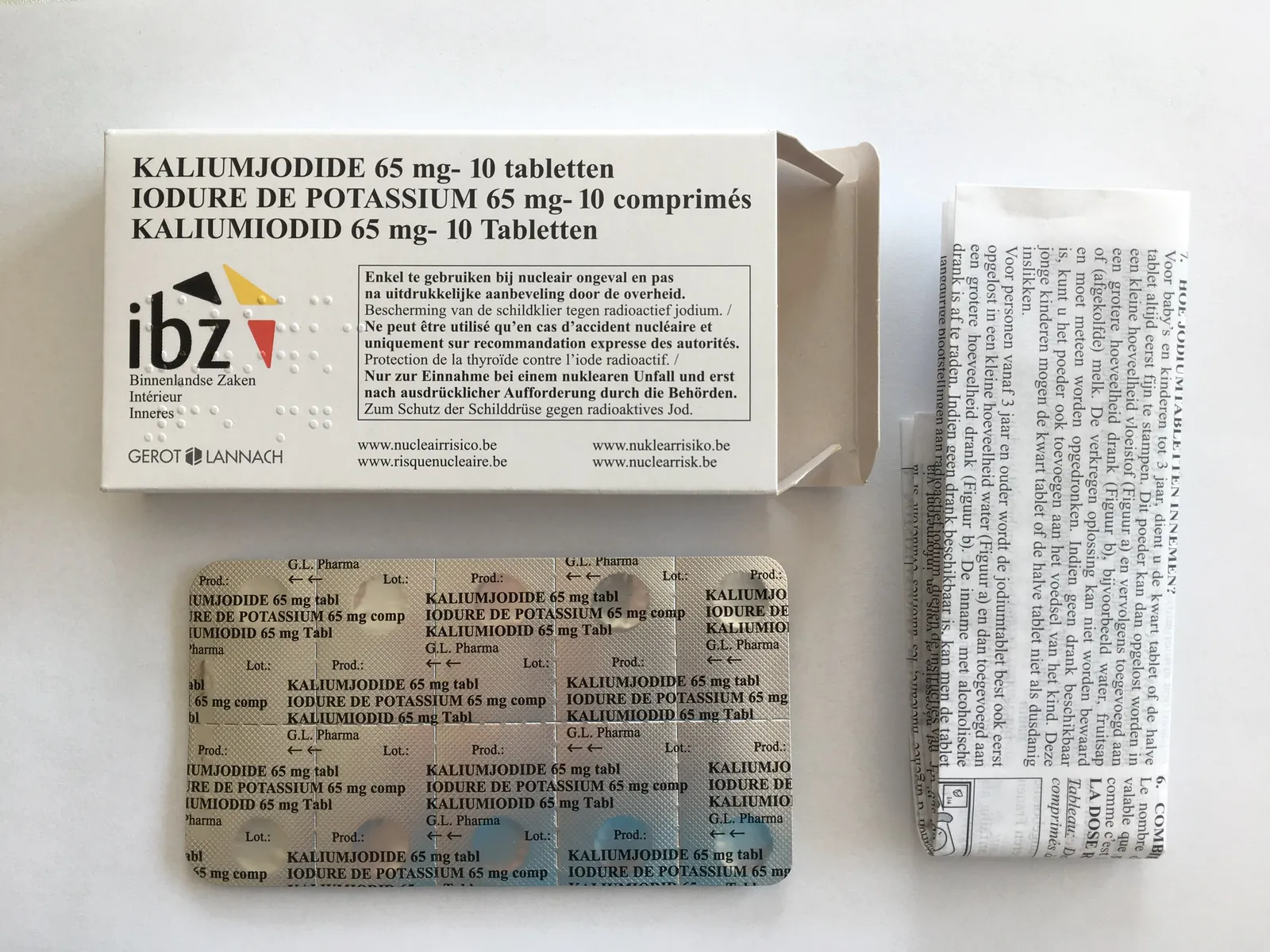 Open potassium iodide tablet box, with its outer cardboard carton, folded leaflet and blister of 10 tablets