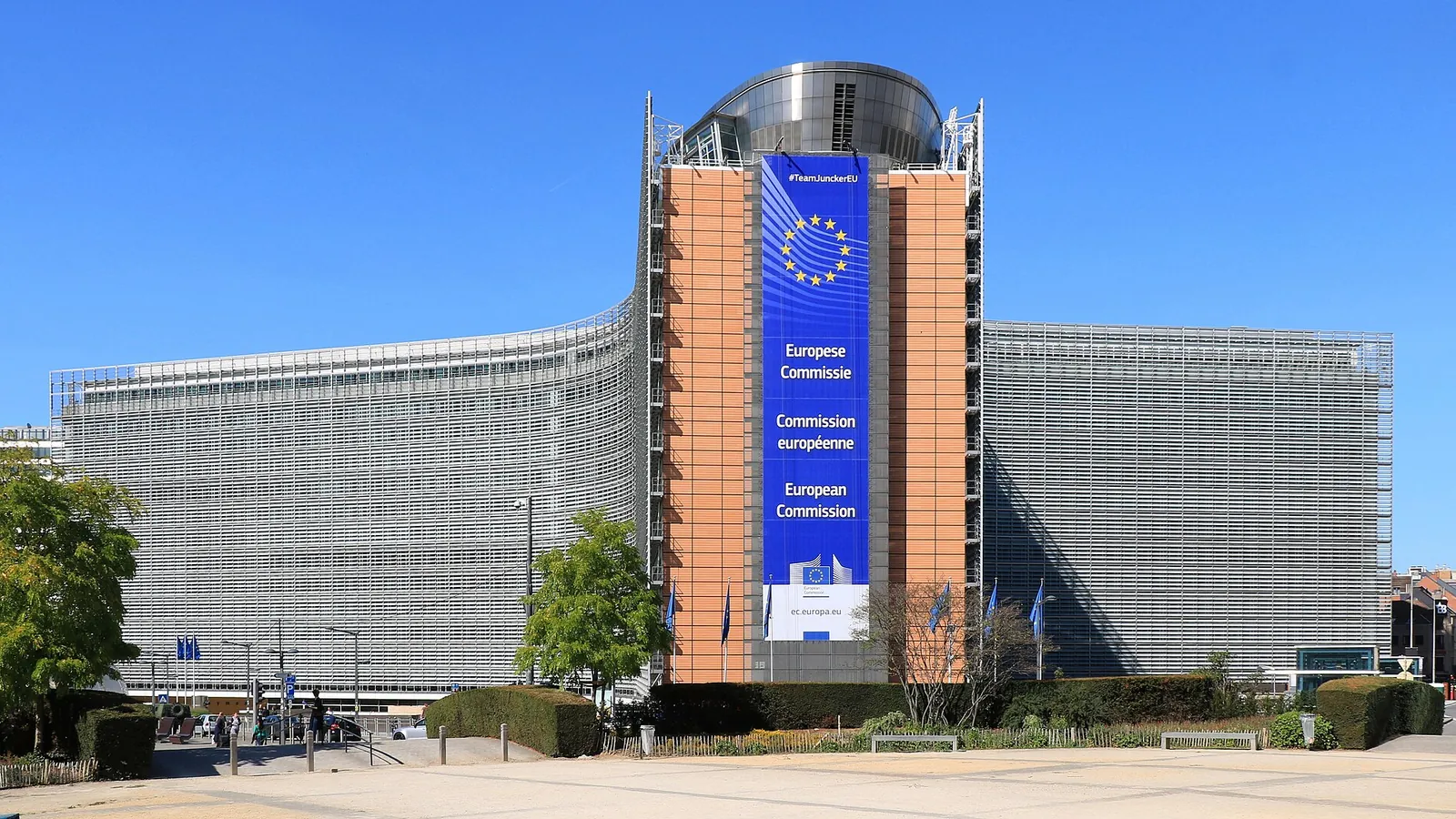 Façade of the Berlaymont, European Commission headquarters in Brussels, with a vertical Commission banner