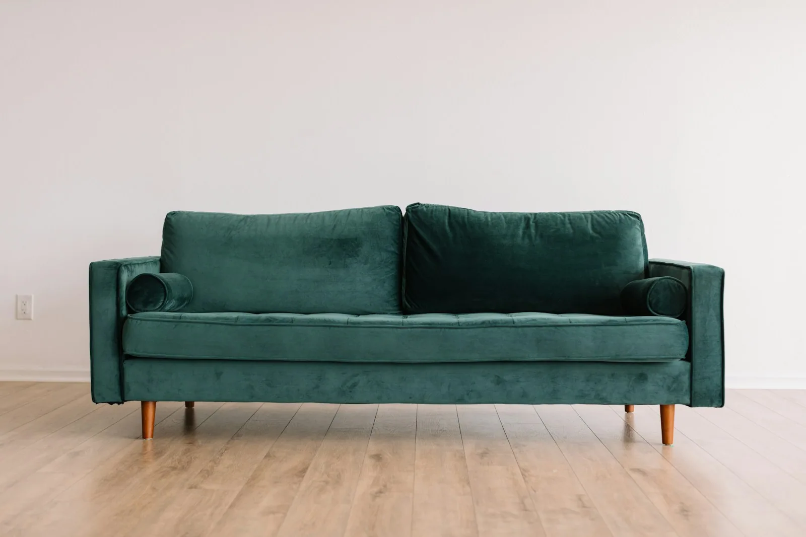 Green sofa in a minimalist interior - every piece of furniture sold in Europe will soon carry an environmental identity record